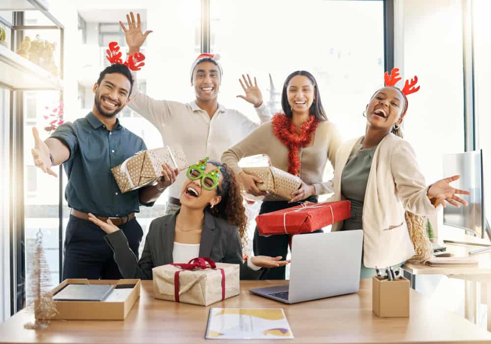 group of friends smile with christmas gifts