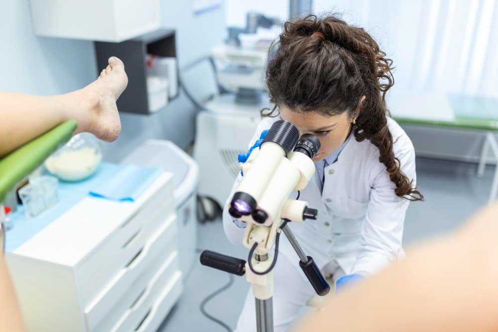 female doctor while performing a colposcopy