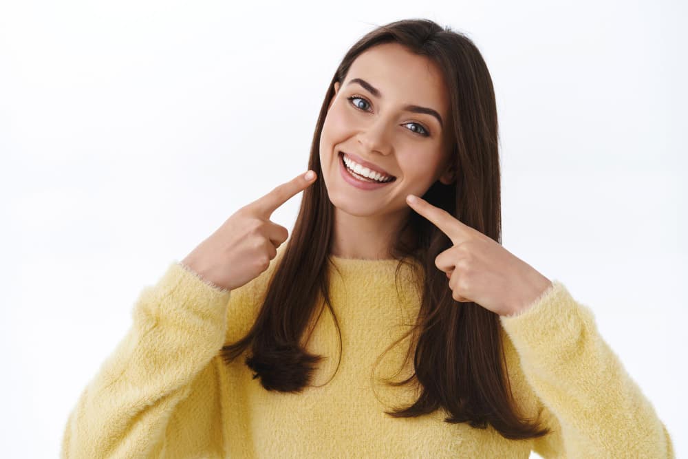 brunette girl indicates smile teeth