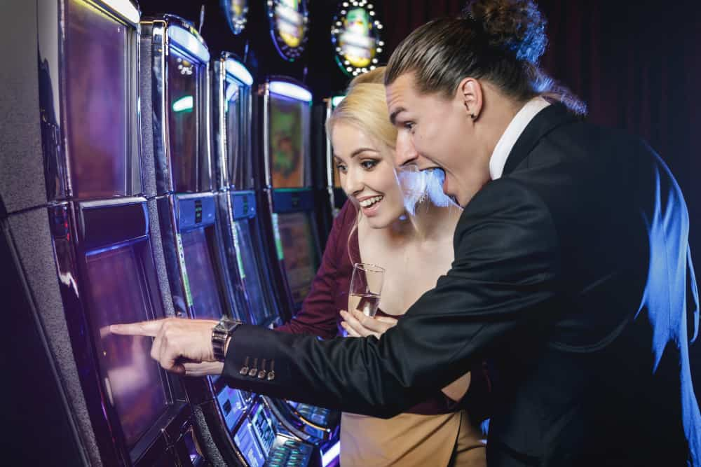 two boys indicating a slot machine