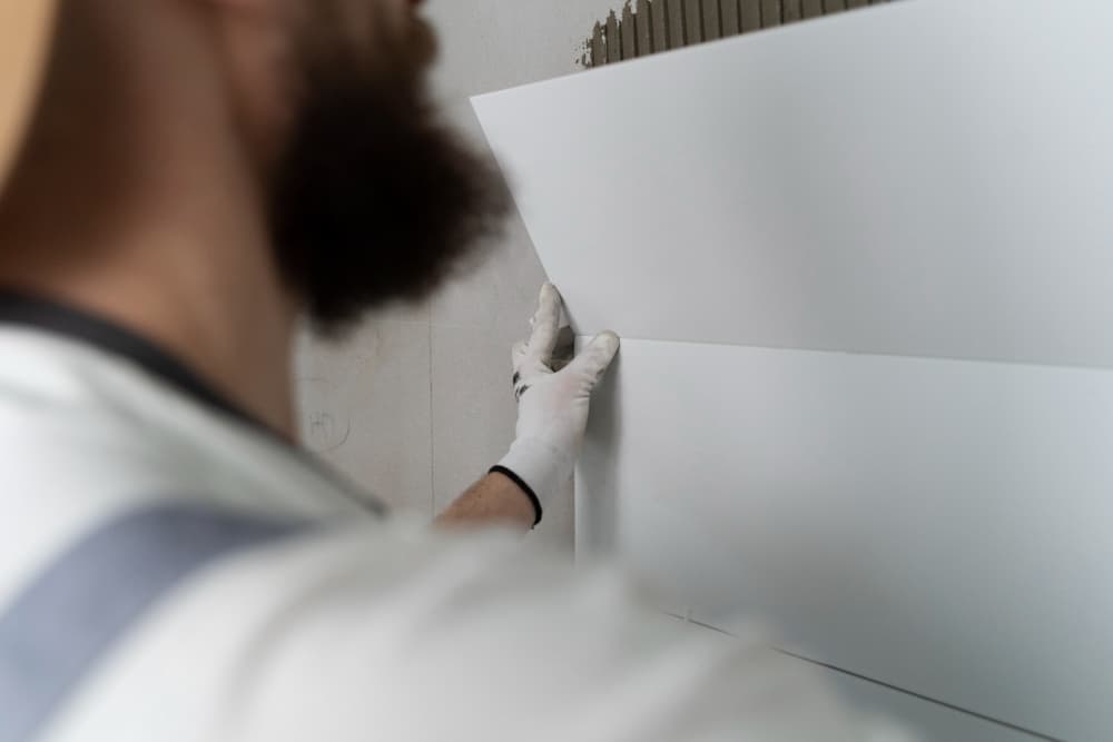 man installing anti-humidity plates