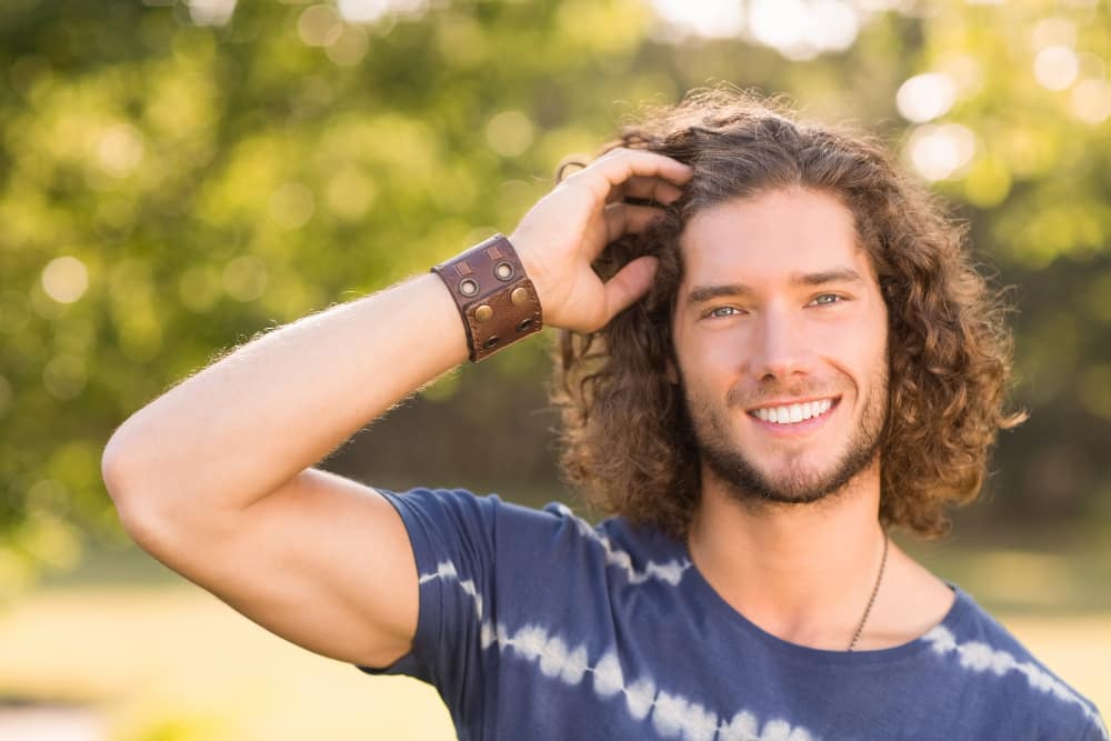 smiling man with long hair