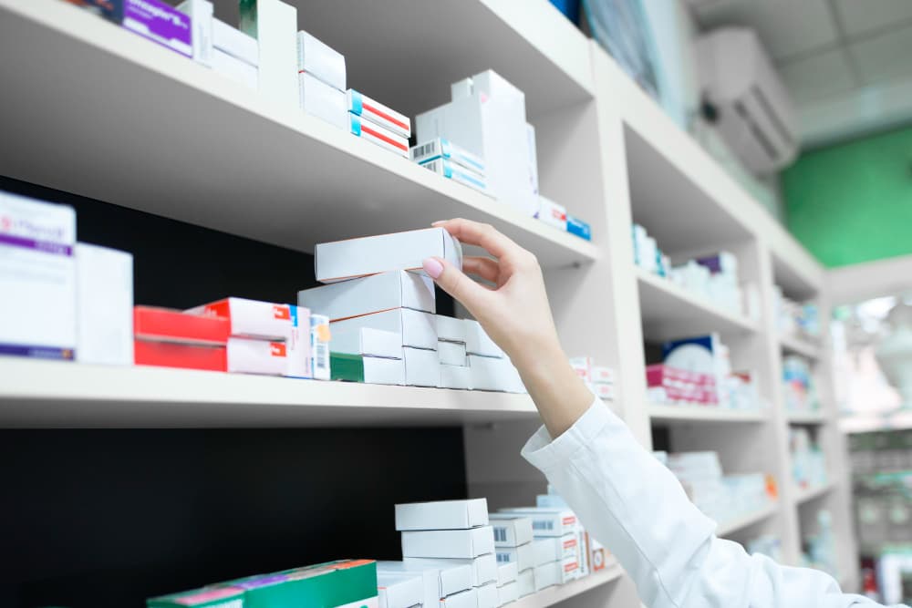 pharmacist's hand taking a medicine